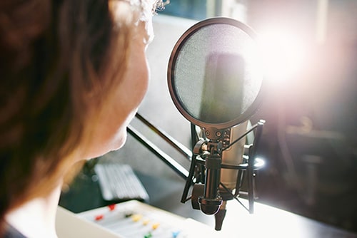 Side view of a woman recording an adoption podcast